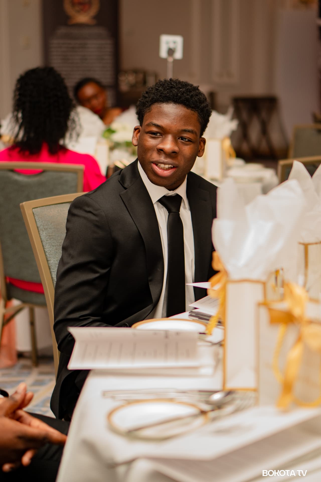 A guest seated at a banquet table during a previous MBOMBO Gala Night edition