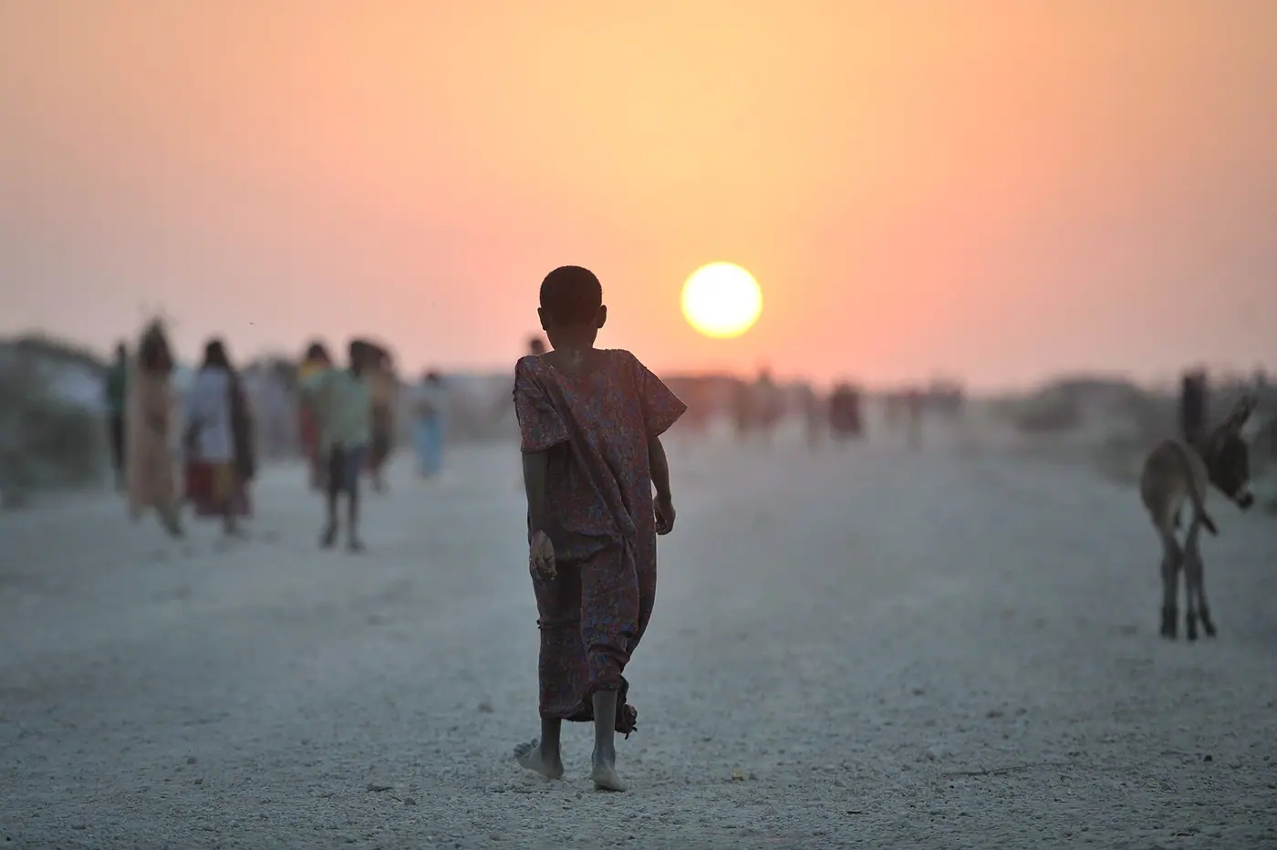 A Somali girl walks down a road at sunset in an IDP camp near the town of Jowhar on December 14. Fighting between clans