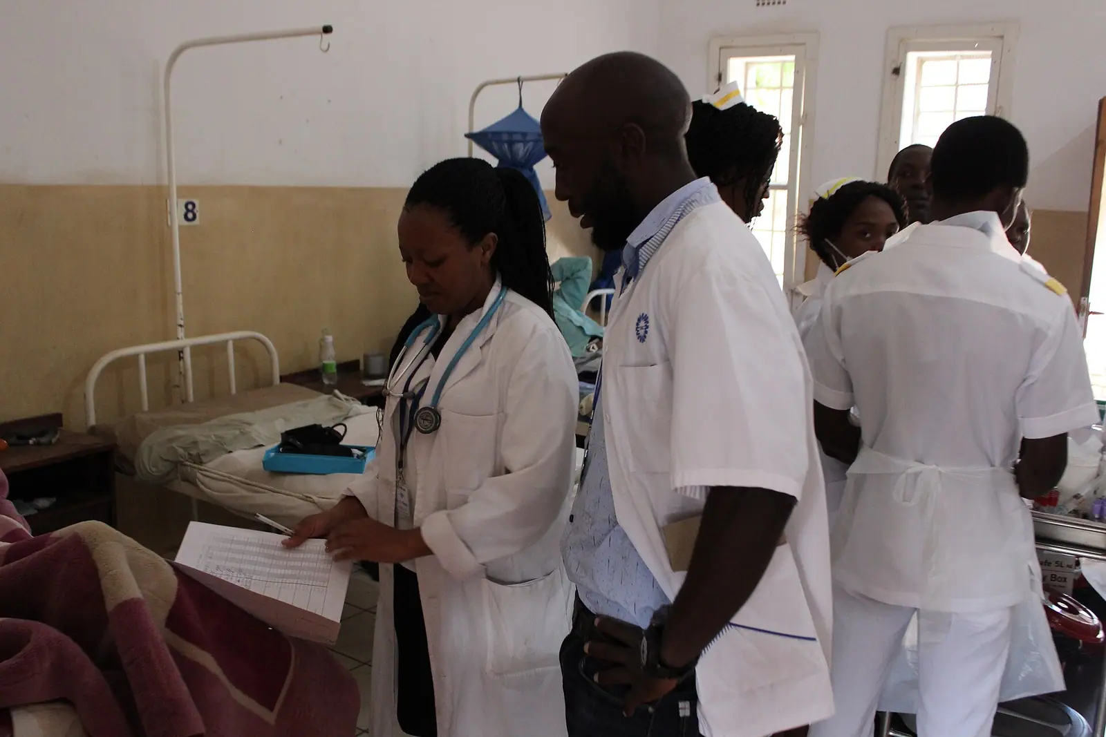 A health worker treating a patient at a community clinic