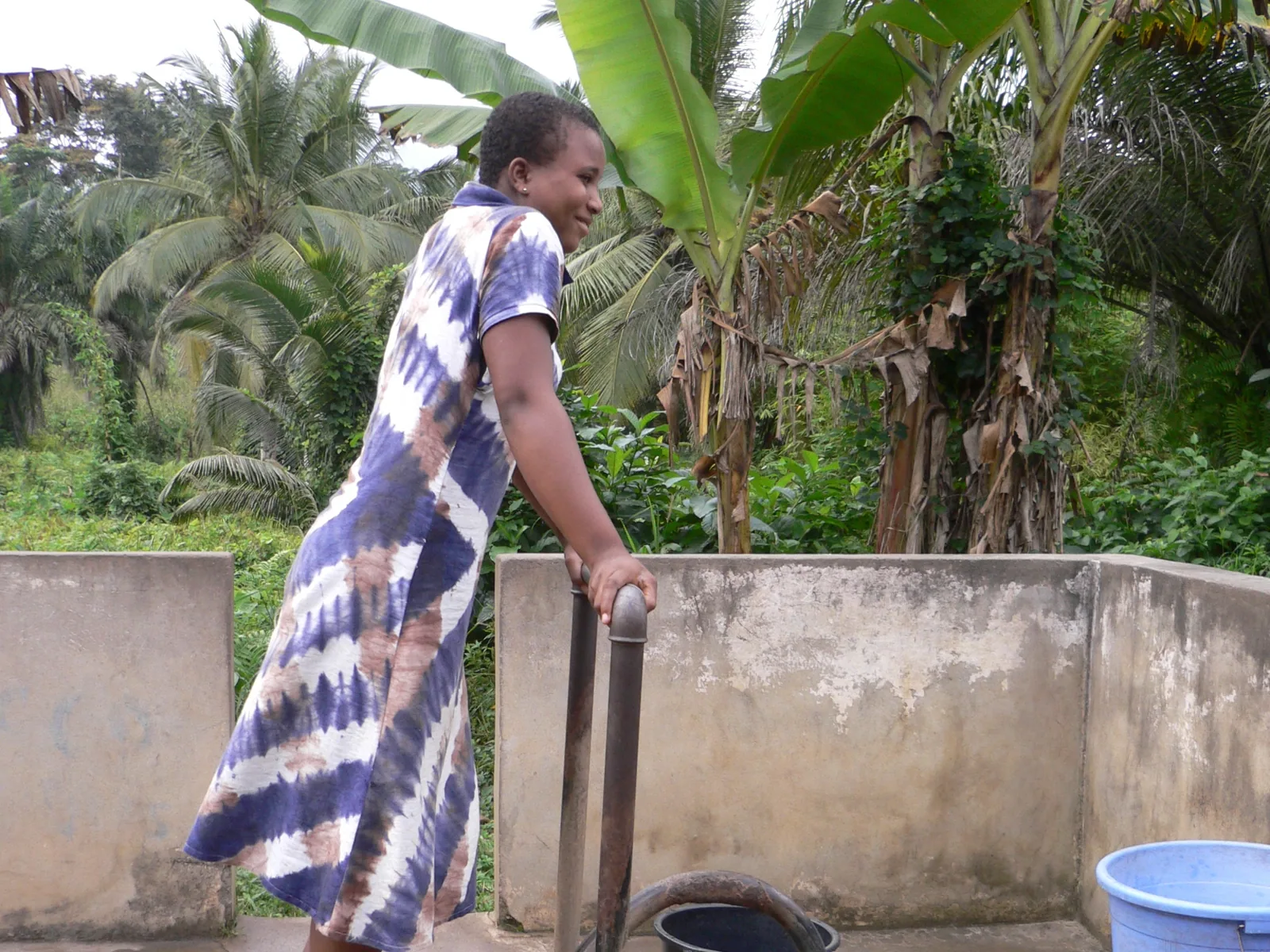 A family pumping clean water in Jukwa Village, Ghana
