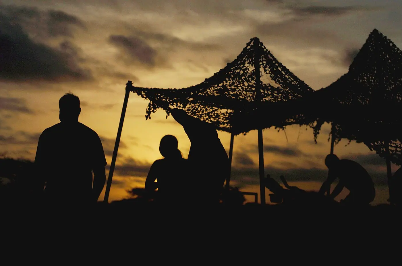 Seabees assigned to Naval Mobile Construction Battalion 74 work out at an improvised gym in at their tent camp in Sankur